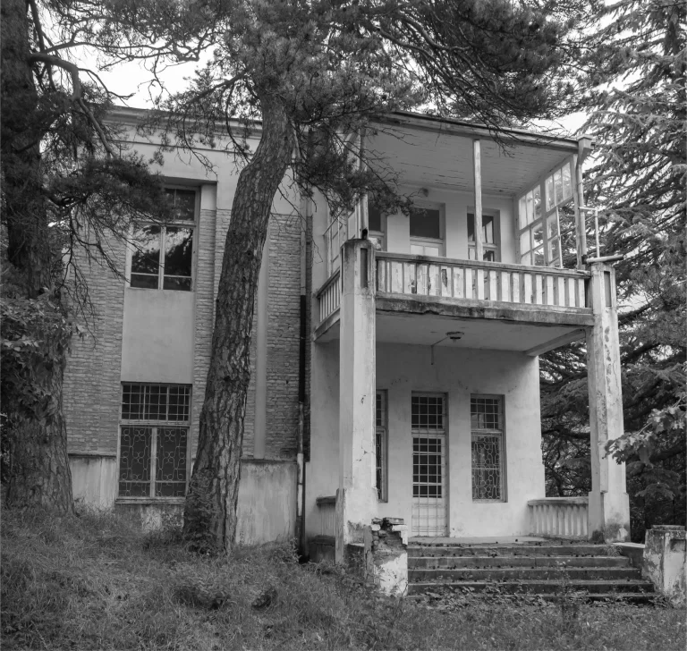 Black and white image of the brick house facade